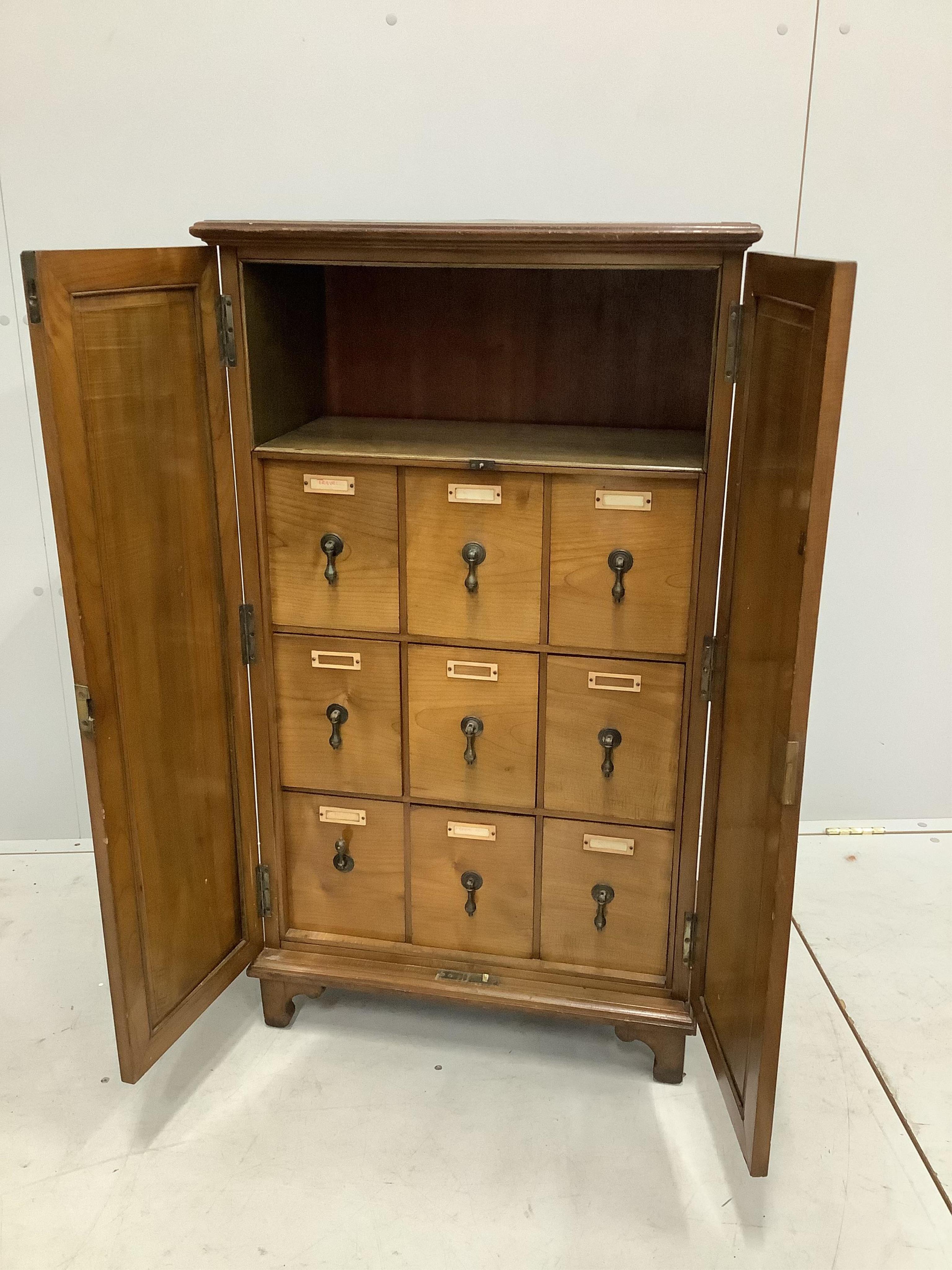 An early 20th century walnut office cabinet fitted with nine deep drawers, width 61cm, height 106cm. Condition - fair, a little faded